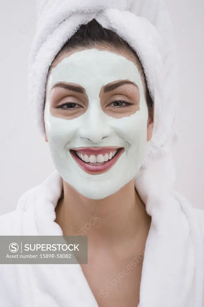 Hispanic woman receiving spa facial treatment