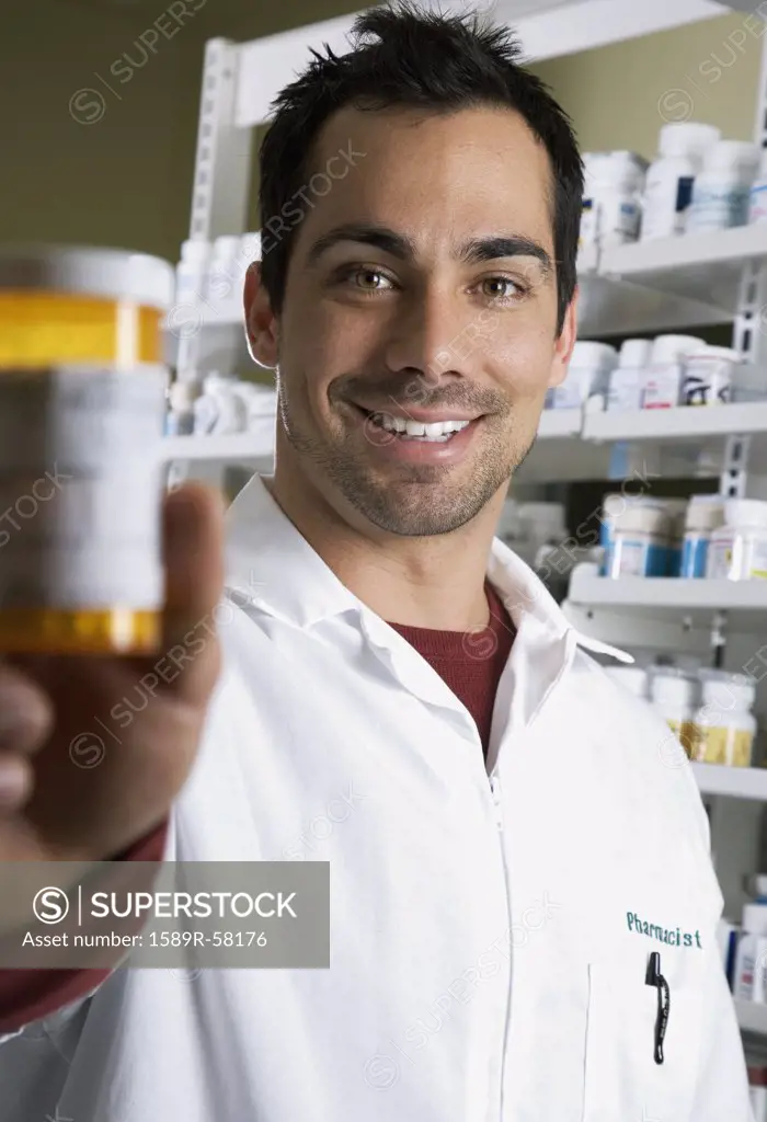 Pacific Islander pharmacist holding medication bottle