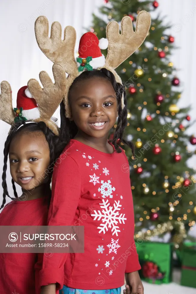 African sisters wearing reindeer antlers