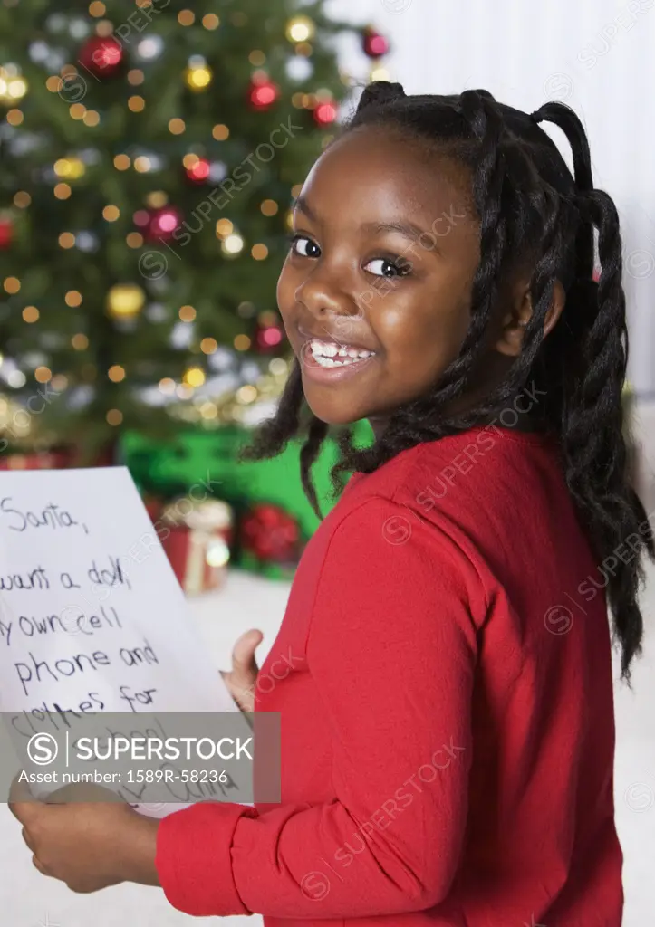 African girl holding letter for Santa Claus