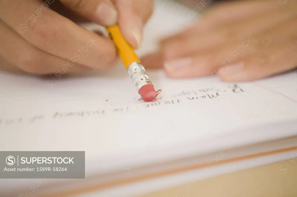 African woman erasing in notebook