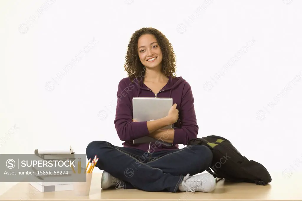 African woman hugging laptop