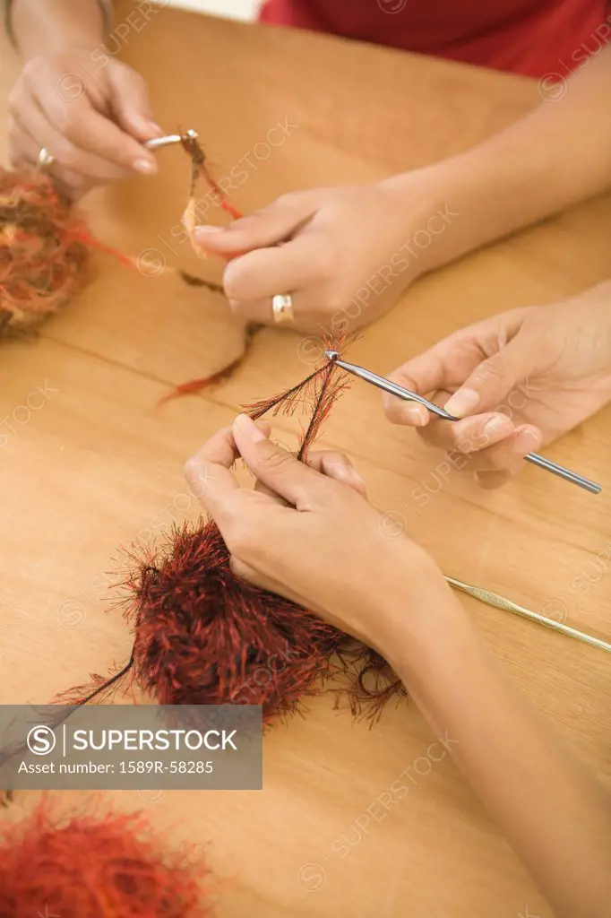 Multi-ethnic women crocheting