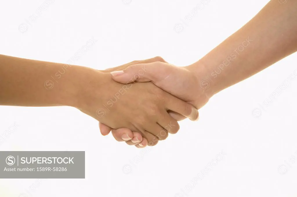 Multi-ethnic women shaking hands