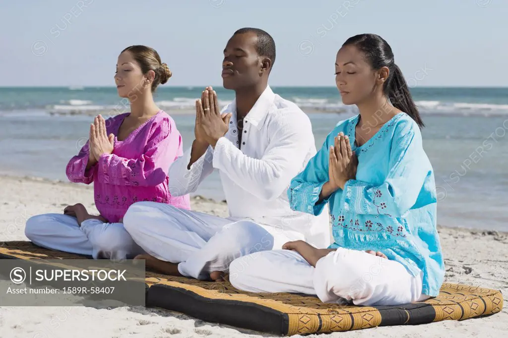 Multi-ethnic friends meditating