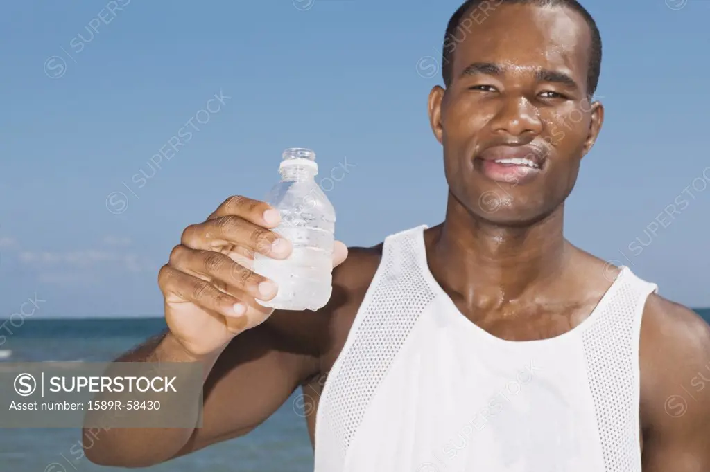 African man holding water bottle