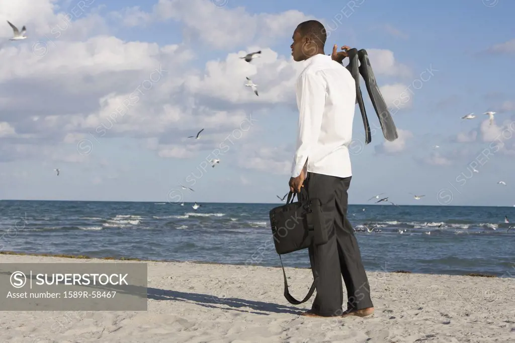 African businessman standing on beach