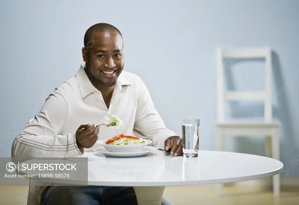 African man eating dinner