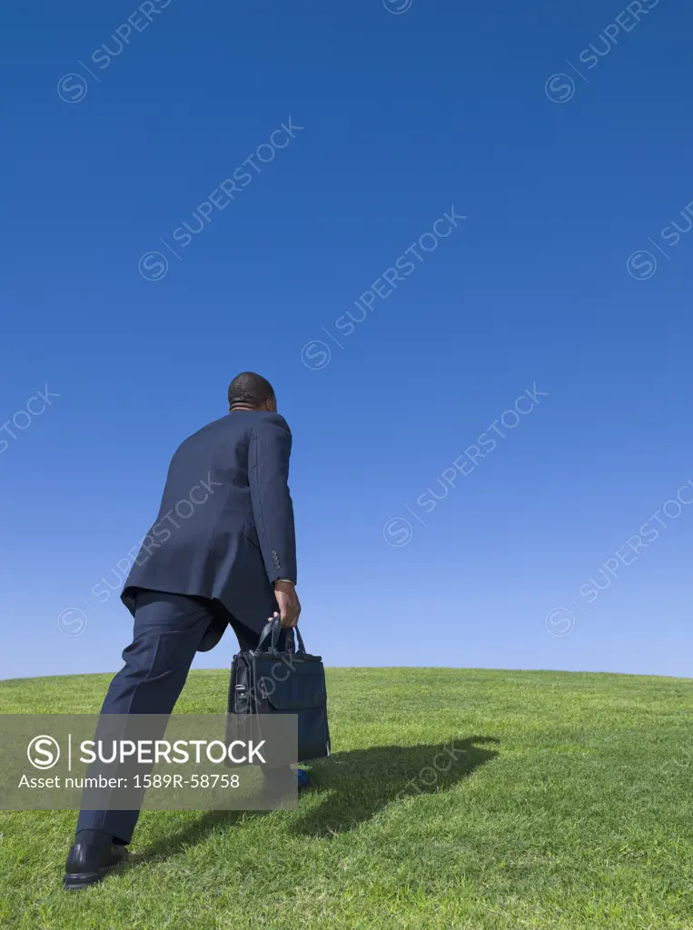 African businessman walking uphill