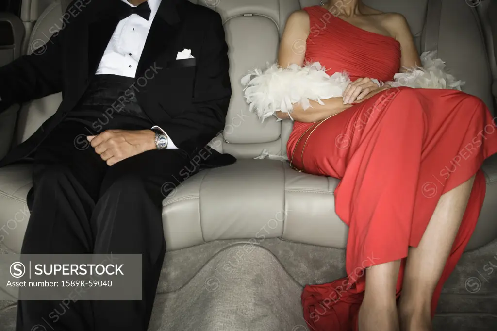 Senior African couple in backseat of limousine