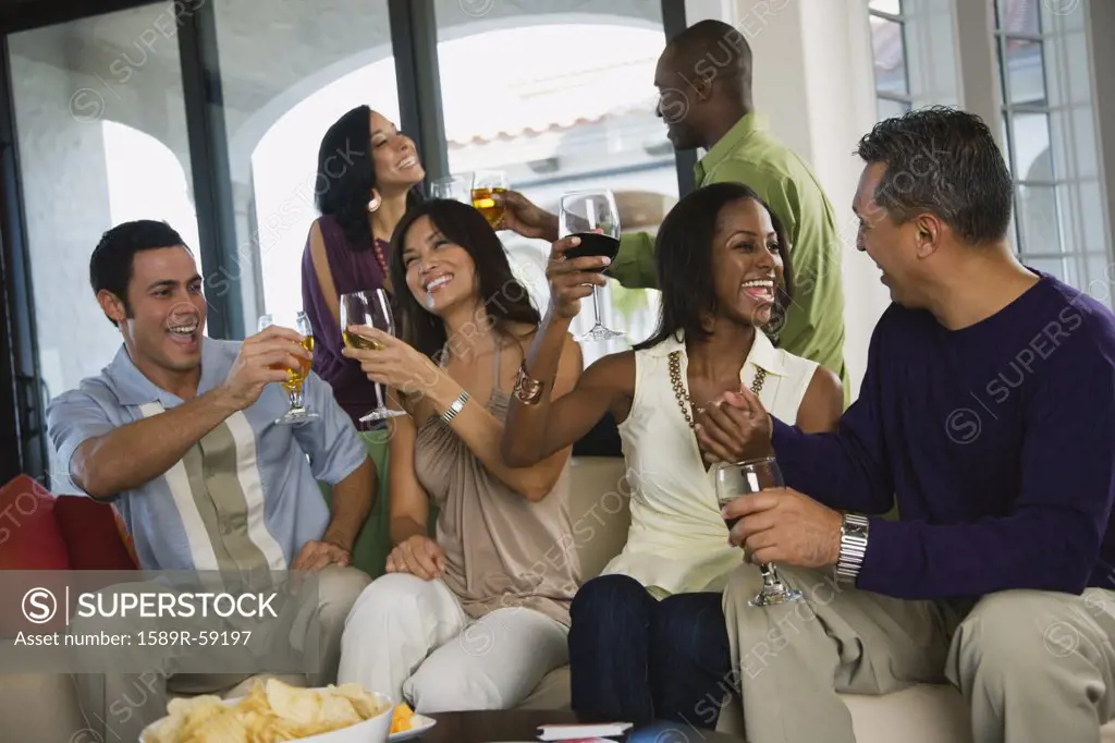 Multi-ethnic friends toasting at party