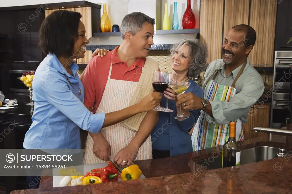Multi-ethnic friends toasting with wine