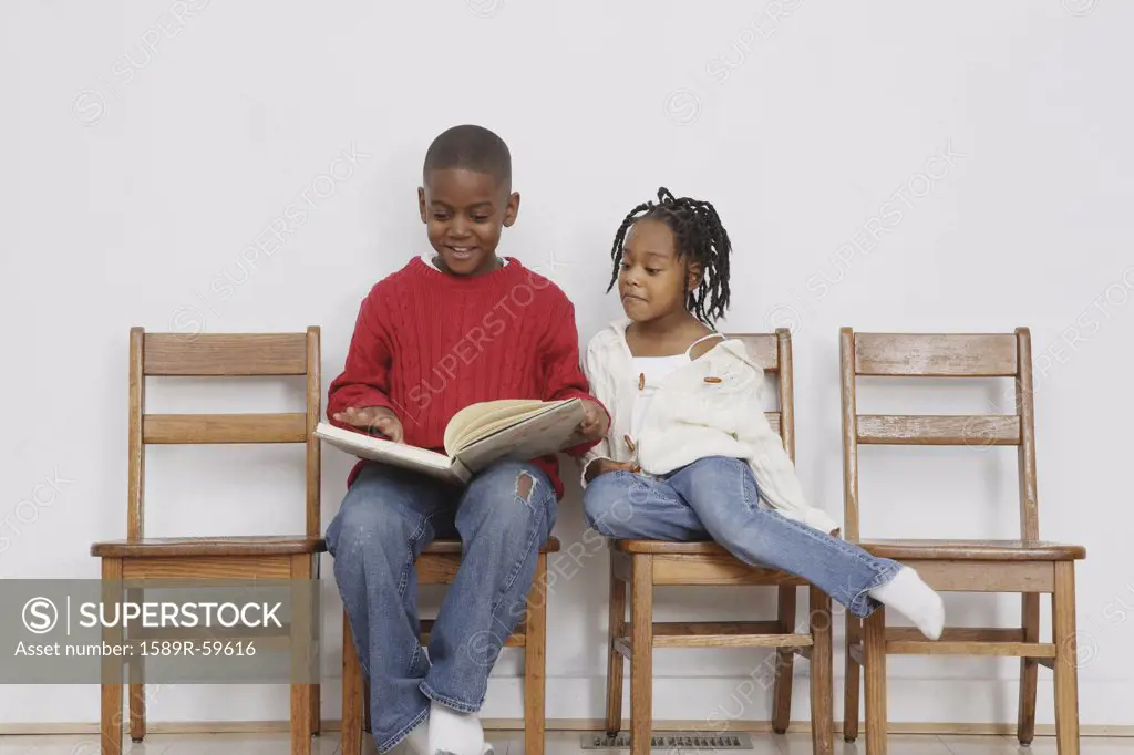 African boy reading to sister