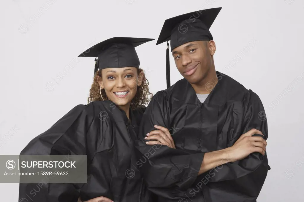 African couple wearing graduation caps and gowns