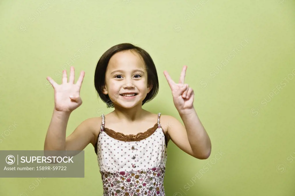 Asian girl holding up six fingers