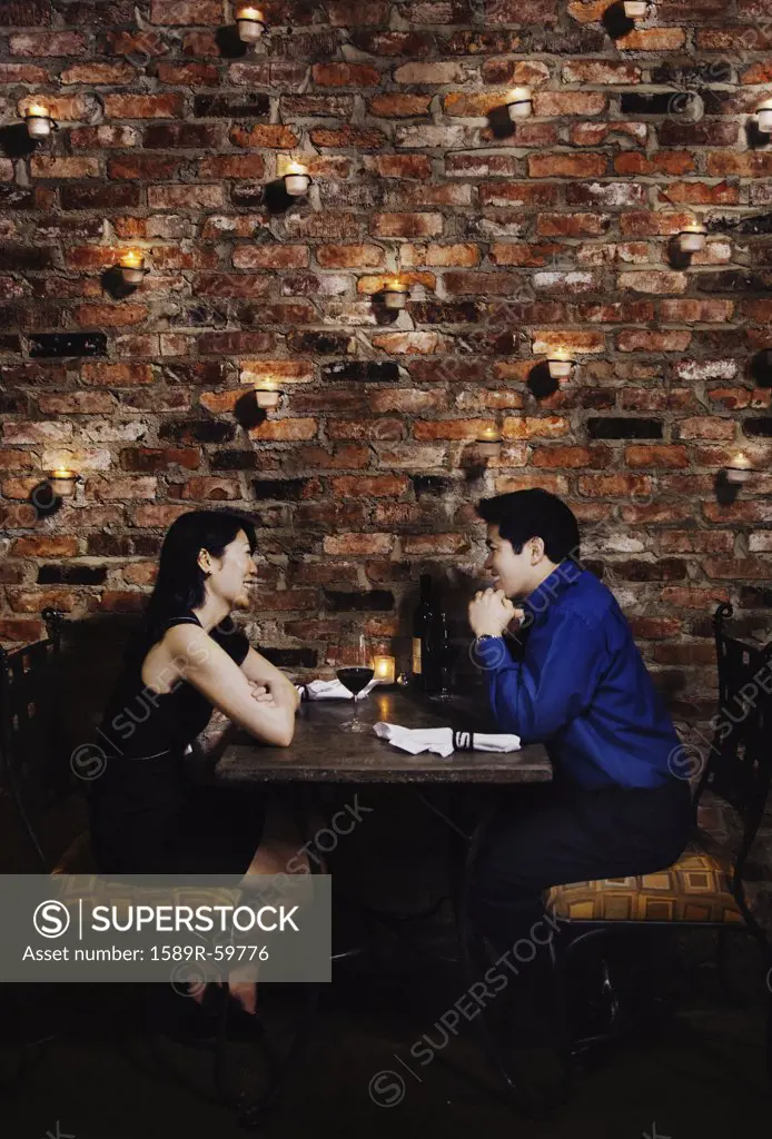 Asian couple eating at restaurant