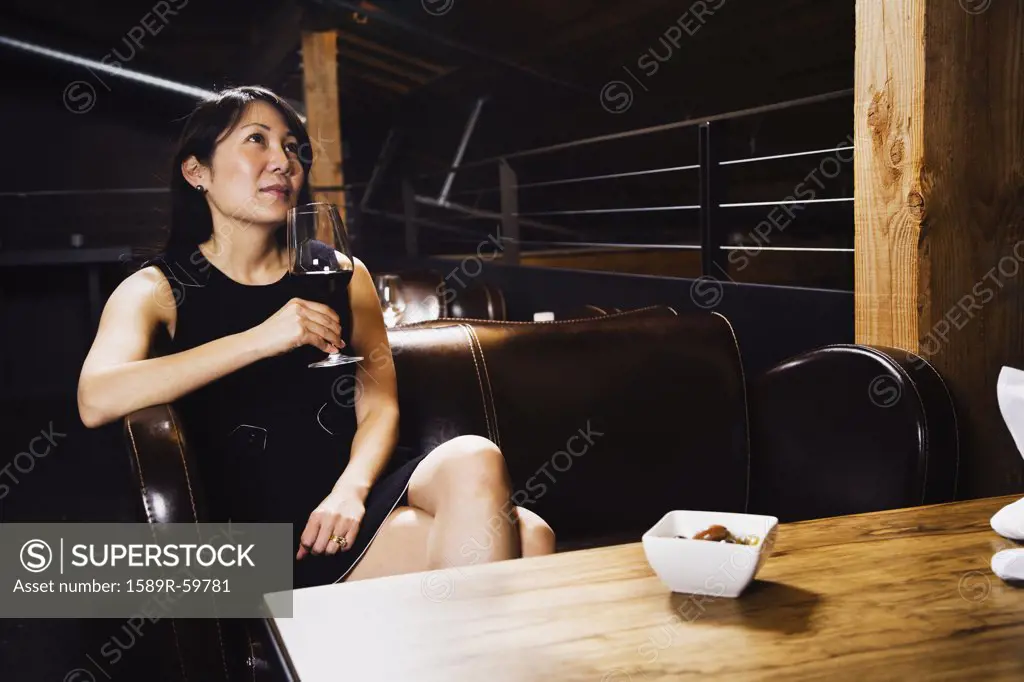 Asian woman drinking wine