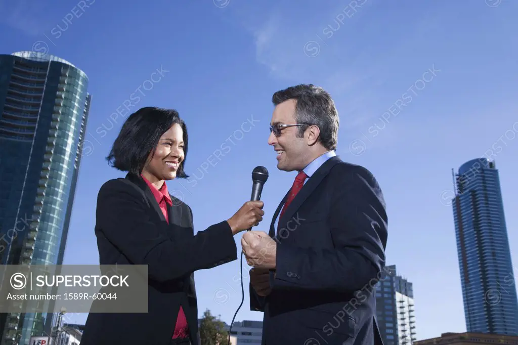African female reporter interviewing businessman