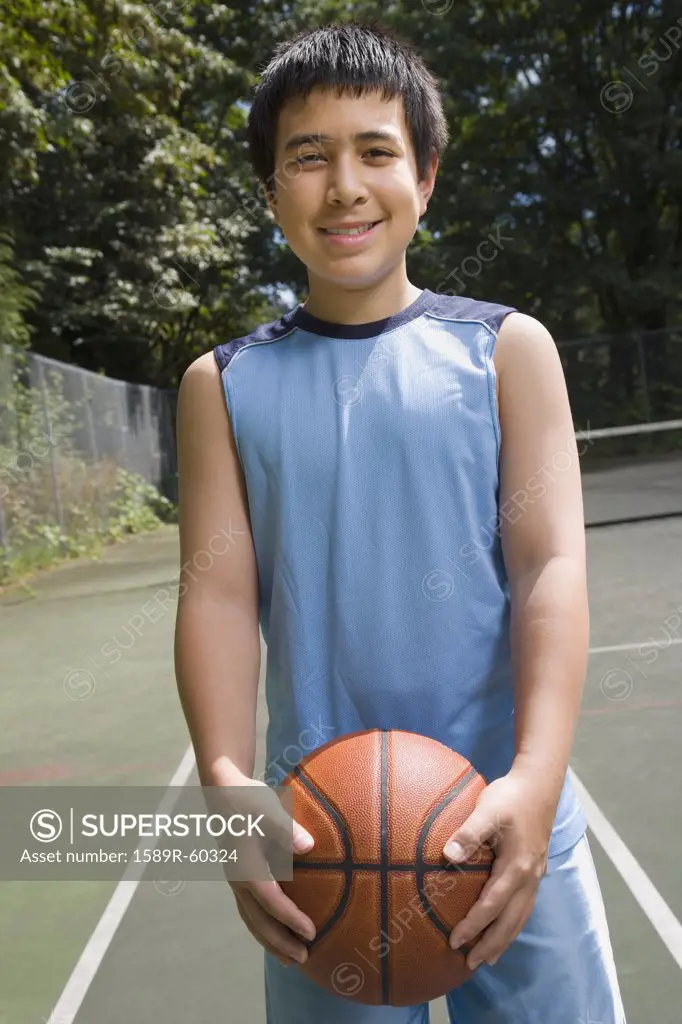 Asian boy holding basketball