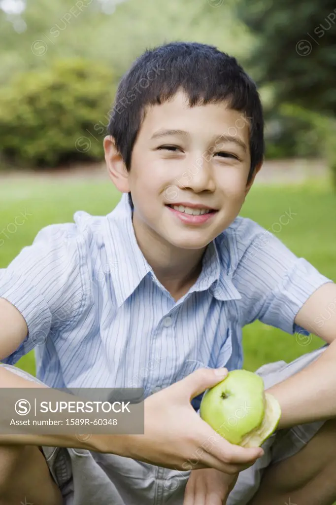 Asian boy holding apple