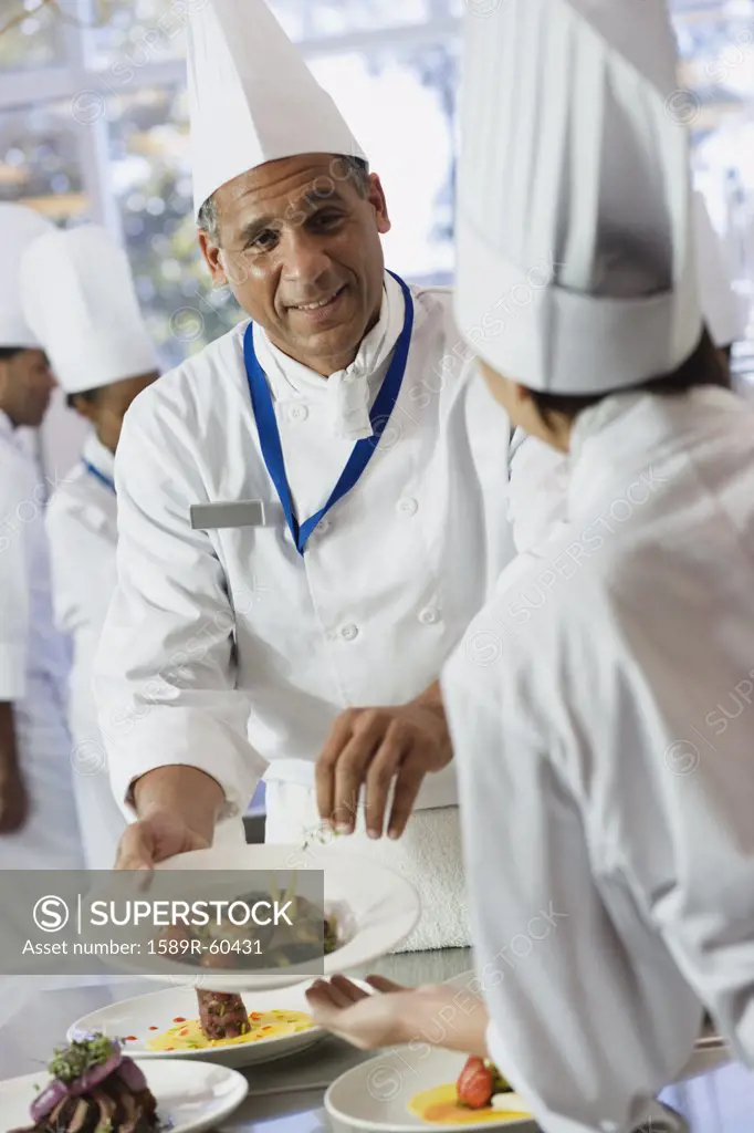 African chef handing plate of food