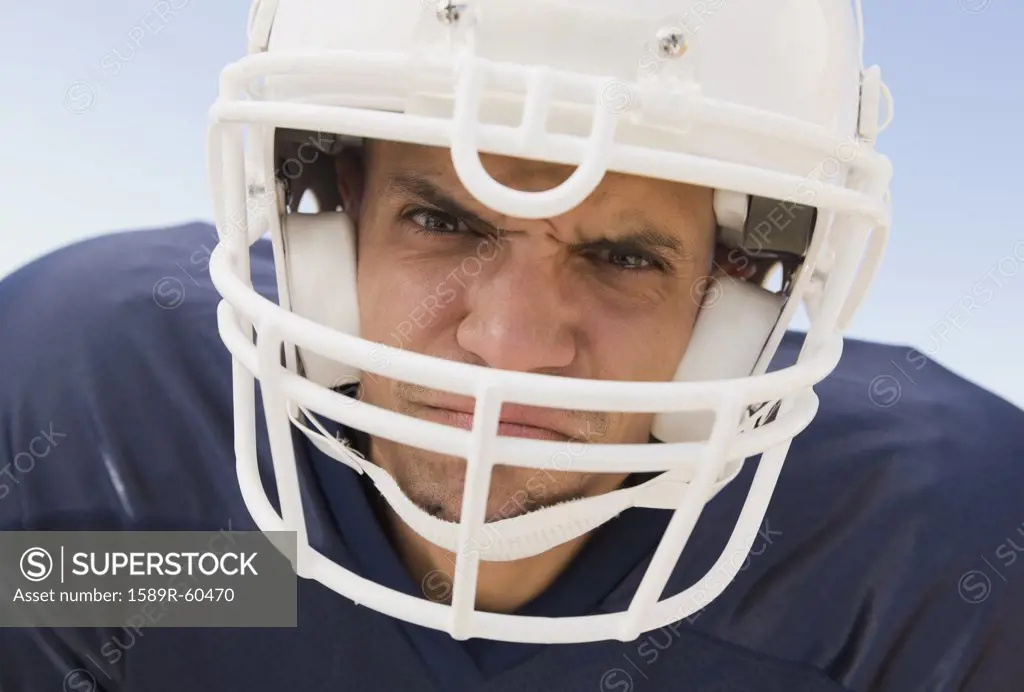 Hispanic male football player wearing helmet