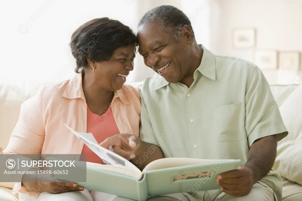 Senior African couple looking at photo album