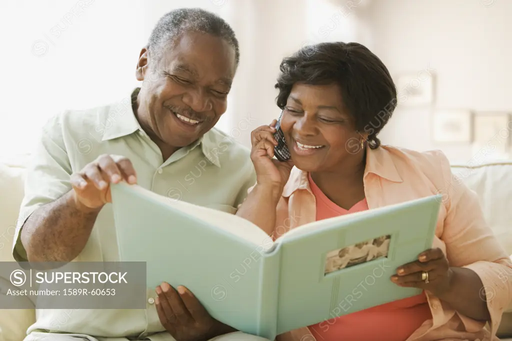 Senior African couple looking at photo album