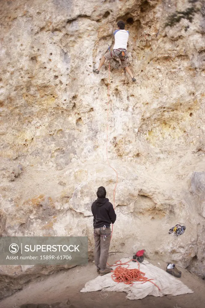 Argentinean men rock climbing together