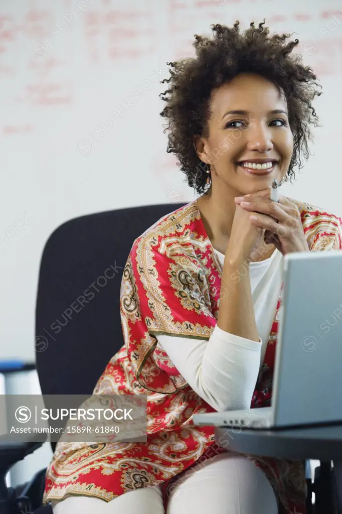 African businesswoman with laptop in office