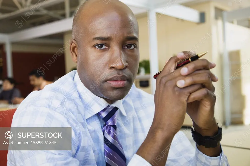 African businessman looking serious in office