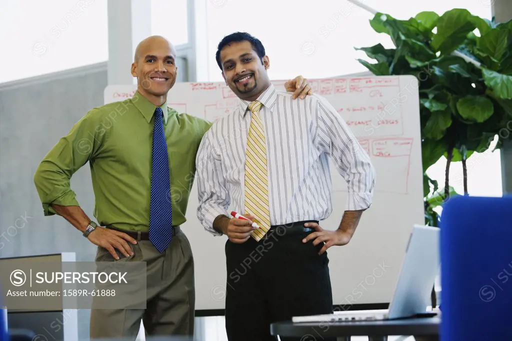 Multi-ethnic businessmen looking confident in office