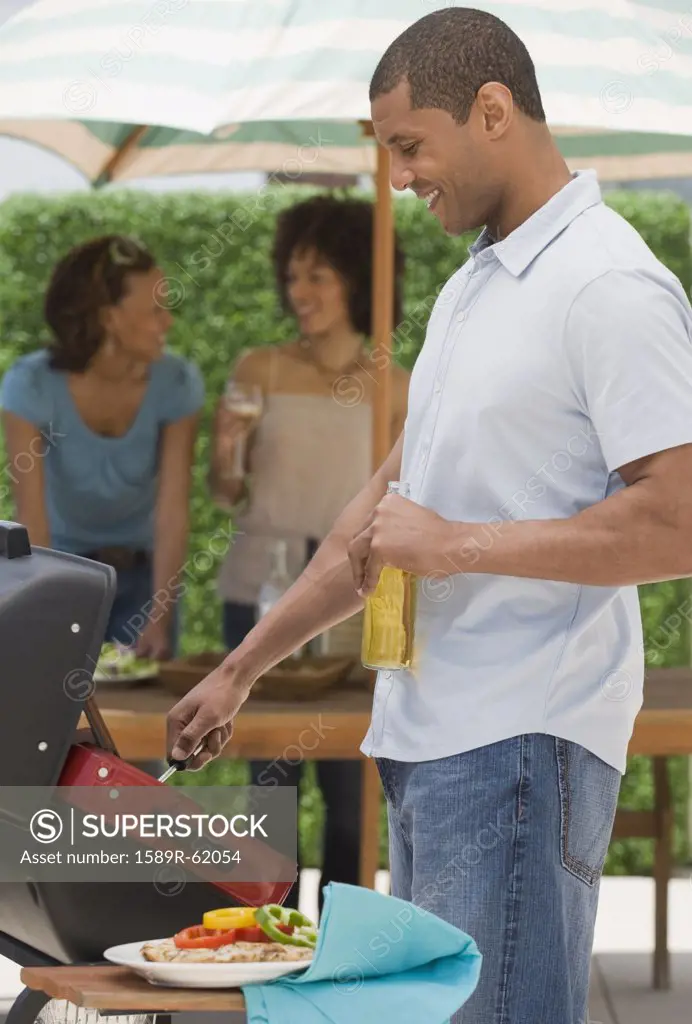 African man and women barbecuing