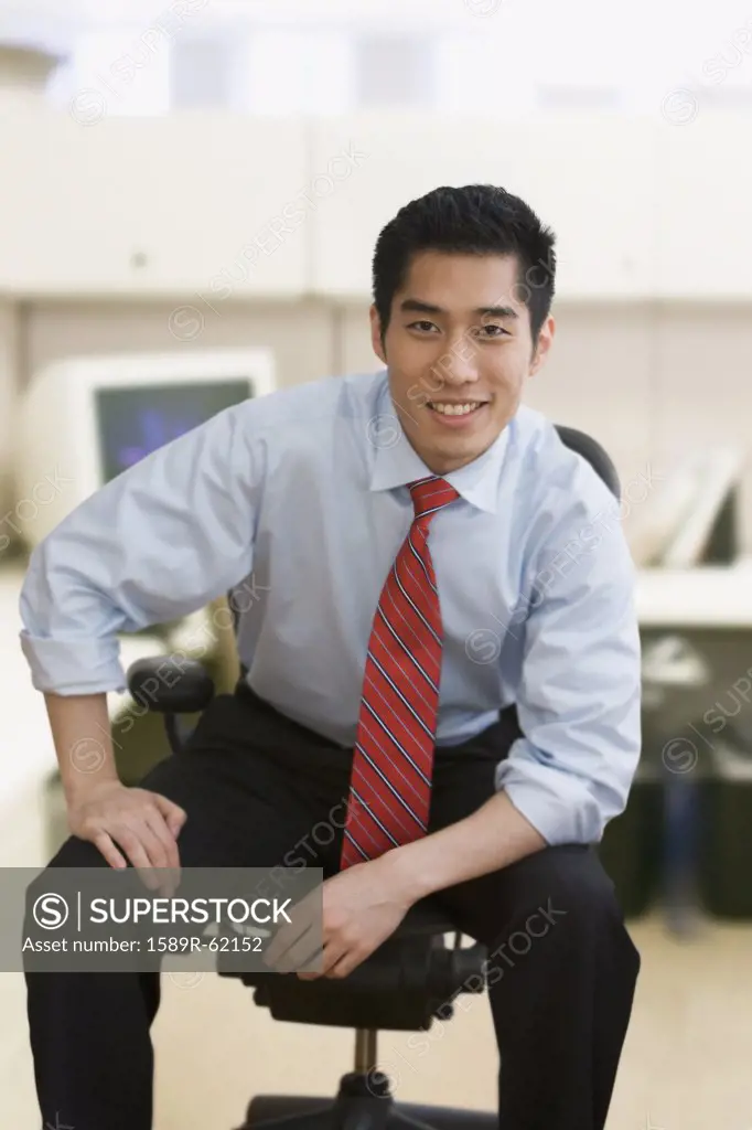 Korean businessman smiling in office
