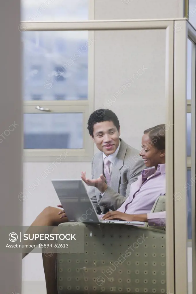 Multi-ethnic business people working on laptop in office