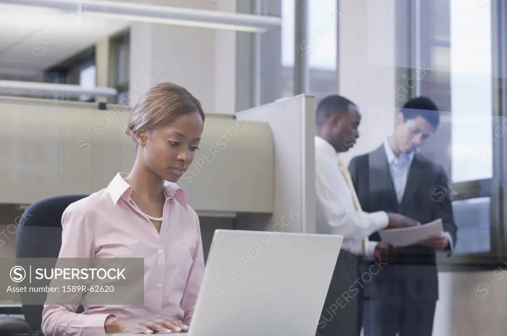 African businesswoman working on laptop in office
