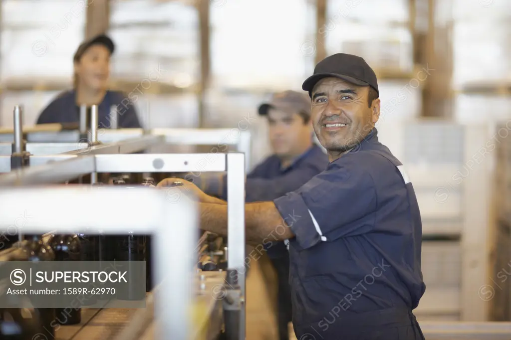 Hispanic man working in bottling factory