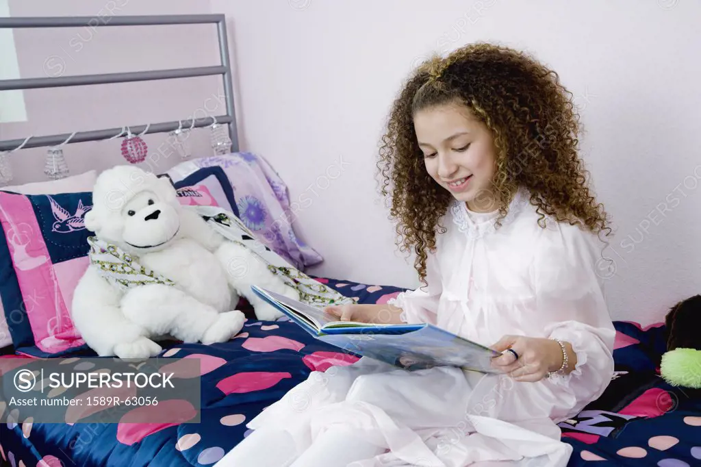 Mixed race girl reading bedtime story