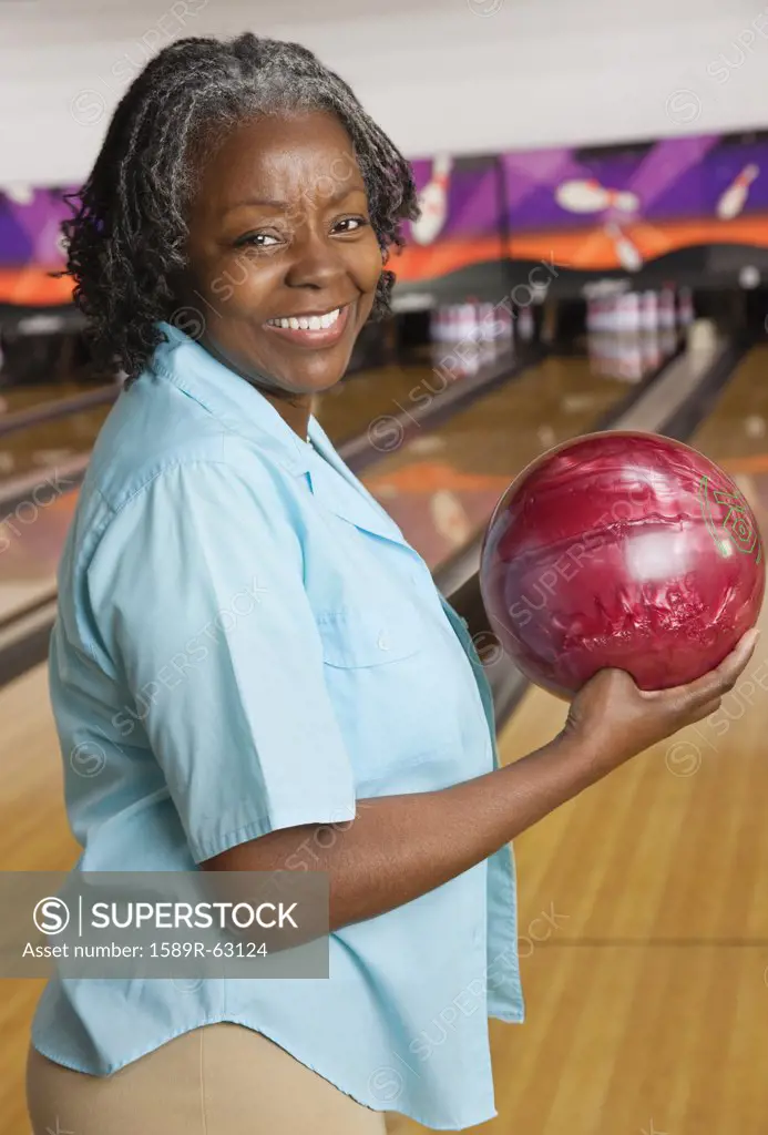 African woman holding bowling ball