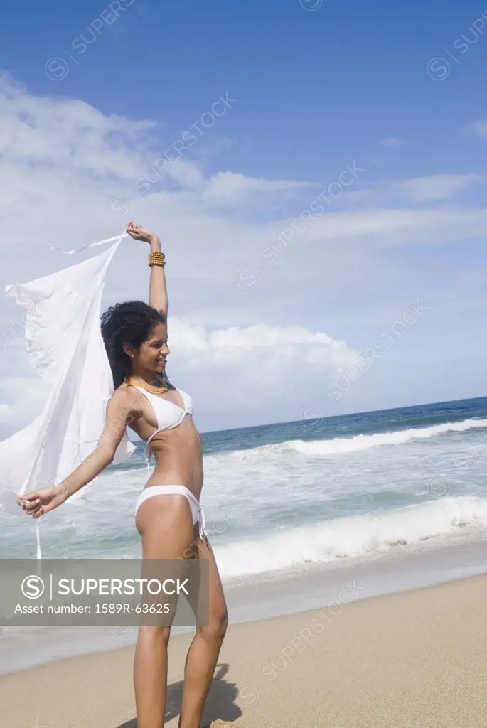 African woman in bikini at beach