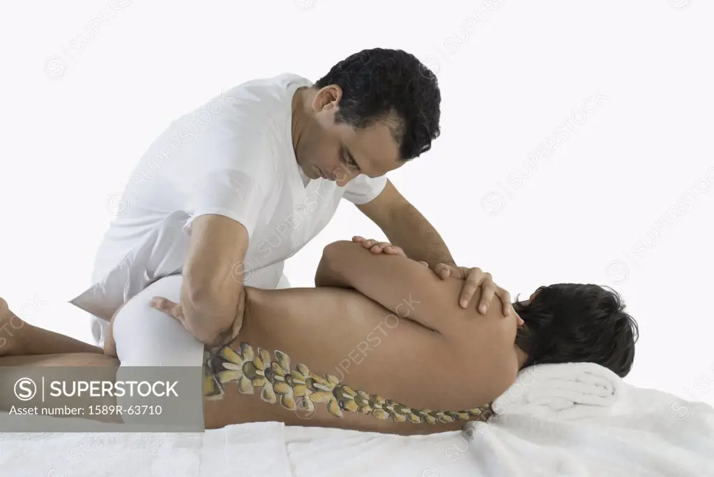 Chiropractor adjusting mans back