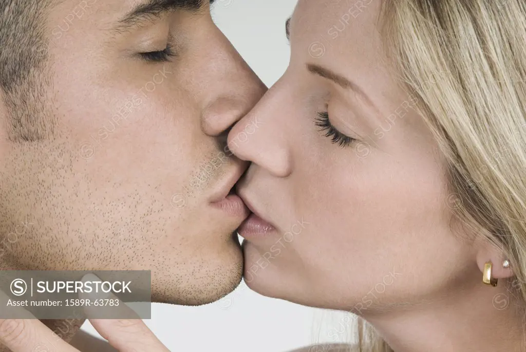 Close up of Hispanic couple kissing