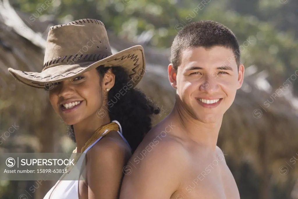 African woman standing back to back with boyfriend