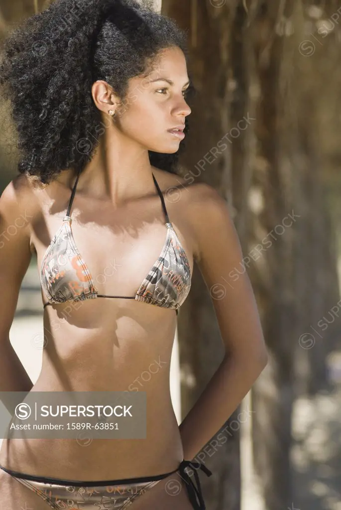 African woman in bikini at beach