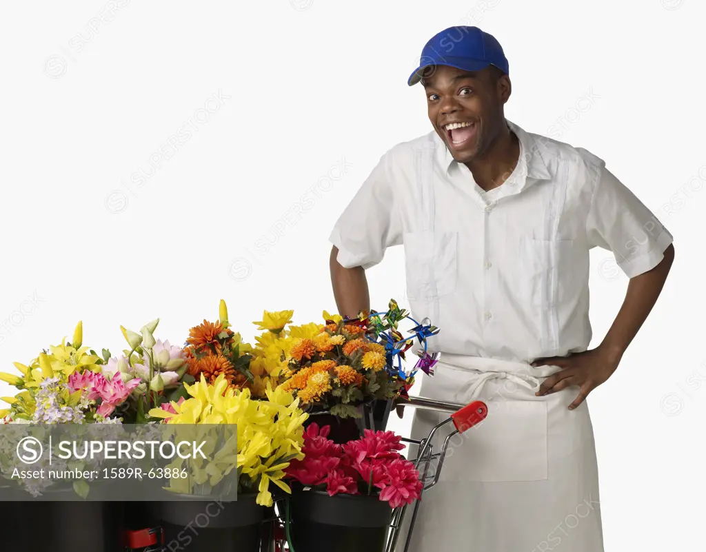 Surprised African florist with cart of flowers