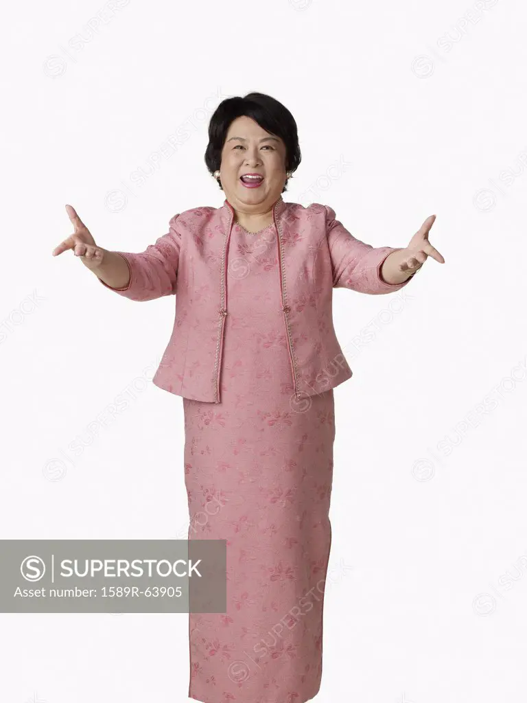 Confident Asian woman with arms outstretched