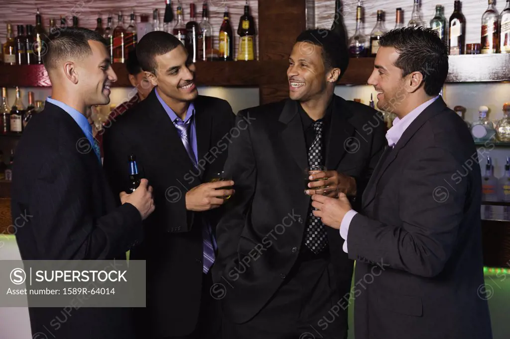 Group of multi-ethnic businessmen drinking in bar