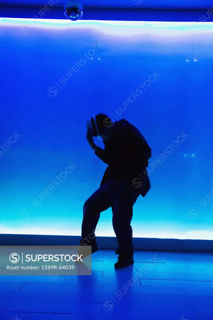 Silhouette of man dancing in nightclub