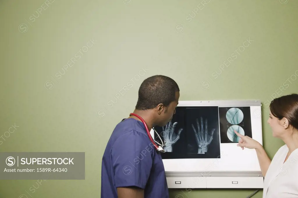 African doctor and nurse examining x-rays