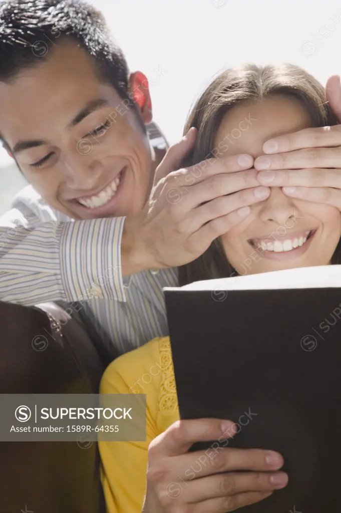 Boyfriend covering girlfriends eyes